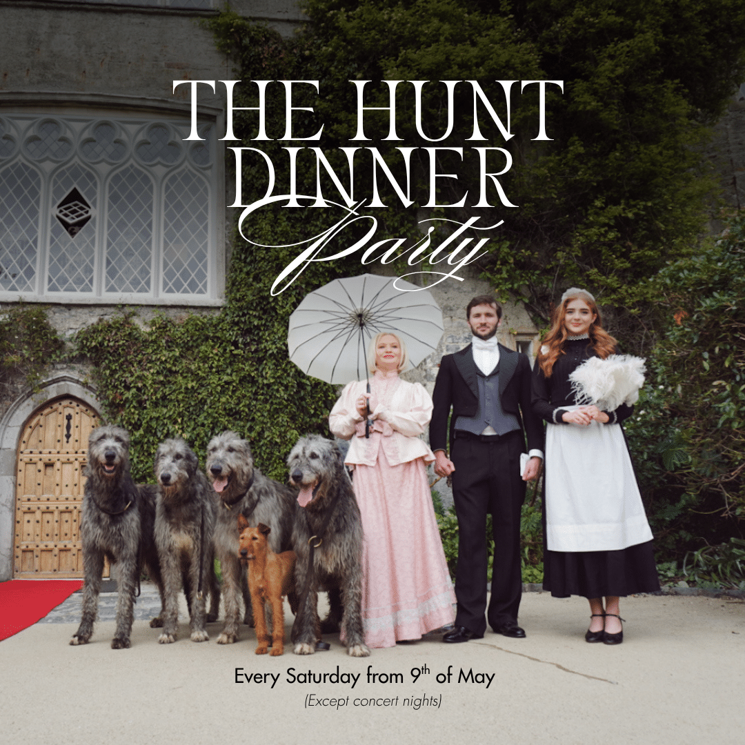 Three people in period costumes stand outside a large building with four large dogs and one smaller dog. One person holds a parasol. Text reads: "The Hunt Dinner Party at Malahide Castle. Every Saturday from 9th of May (Except concert nights).