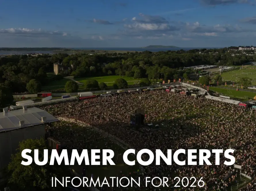 A large outdoor crowd gathers at a summer concert in a green park under a blue sky. Text overlay reads: "Summer Concerts at Malahide Castle – Information for 2026.
