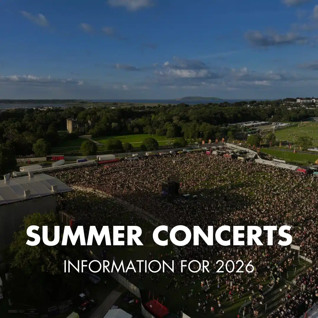 A large outdoor crowd gathers at a summer concert in a green park under a blue sky. Text overlay reads: "Summer Concerts at Malahide Castle – Information for 2026.