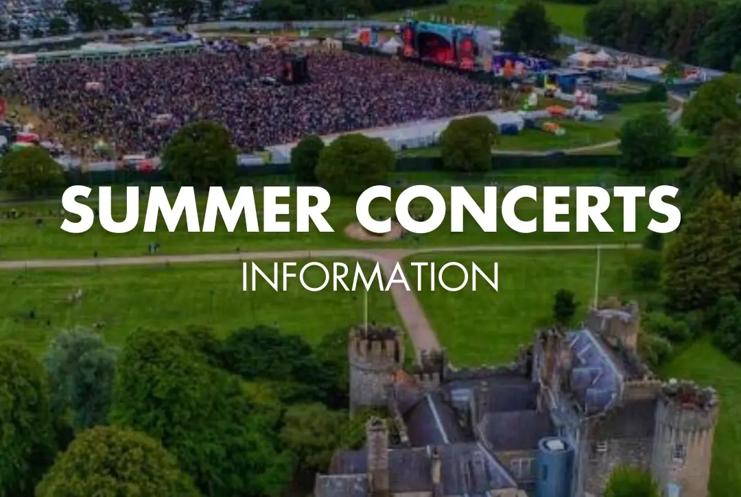 Aerial view of a large outdoor concert crowd near a stage, surrounded by green fields and trees, with Malahide Castle in the foreground. Text reads: "Summer Concerts Information''