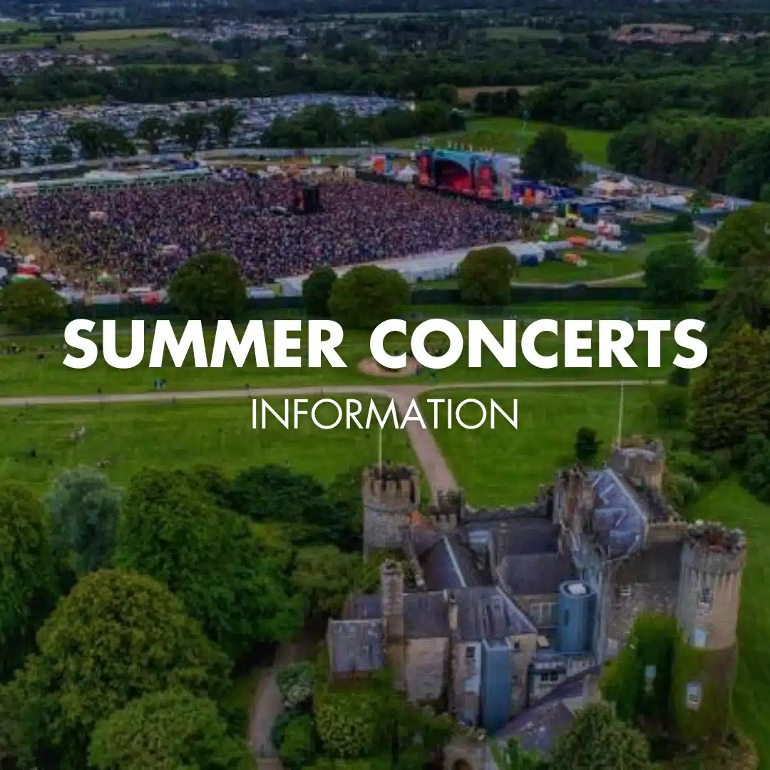 Aerial view of a large outdoor concert crowd near a stage, surrounded by green fields and trees, with Malahide Castle in the foreground. Text reads: "Summer Concerts Information''