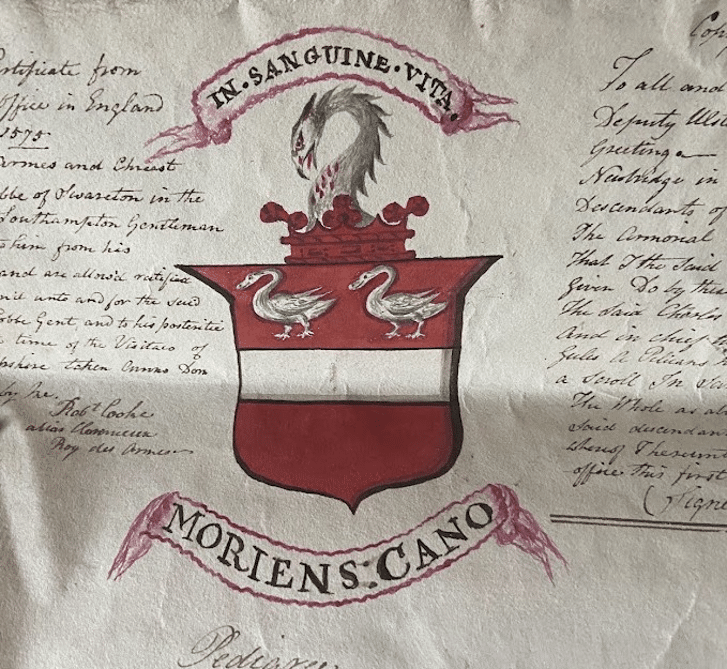 A hand-drawn coat of arms with two birds above a white horizontal band on a red shield, a snake on top, and Latin phrases: "IN SANGUINE VITA" and "MORIENS CANO." Celebrate National Heritage Week with handwritten text surrounding the image.